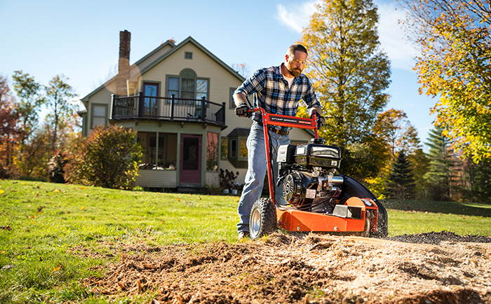 Using a stump grinder to remove a stump.