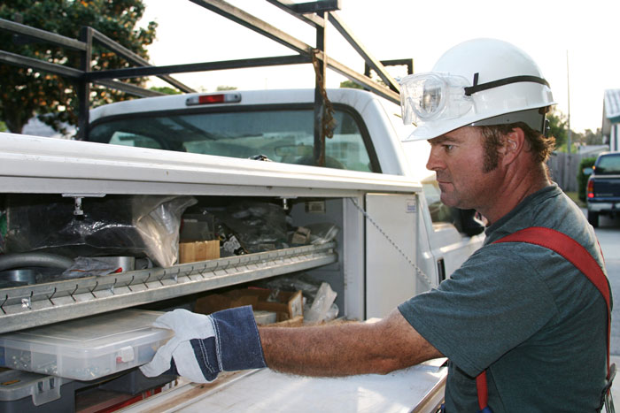 Unloading pickup, hard hat and safety glasses