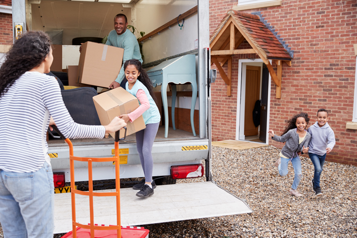 family moving boxes out of truck