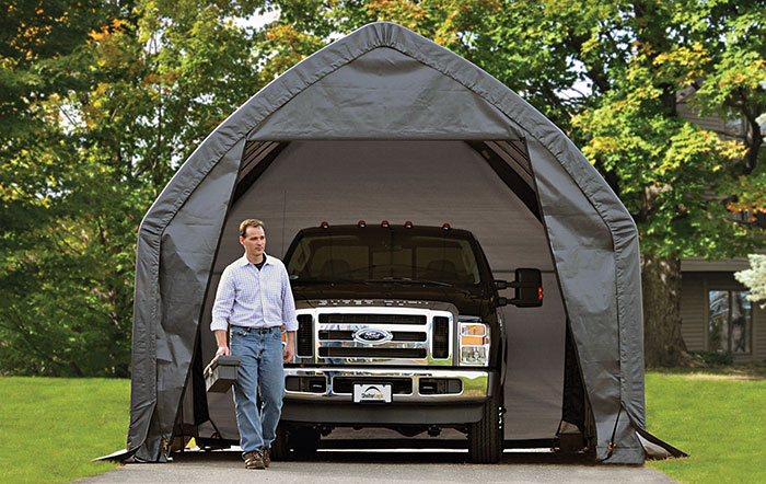 A Ford truck owner exits his Garage-in-a-Box®, his truck  is parked behind him.