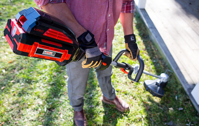 The lightweight cordless electric string trimmer in use.