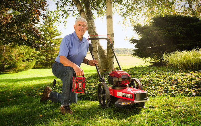 Using a string trimmer with a 64-volt battery.