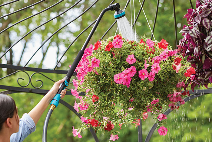 For tall plants, skip the bulky watering can and use a watering wand instead.