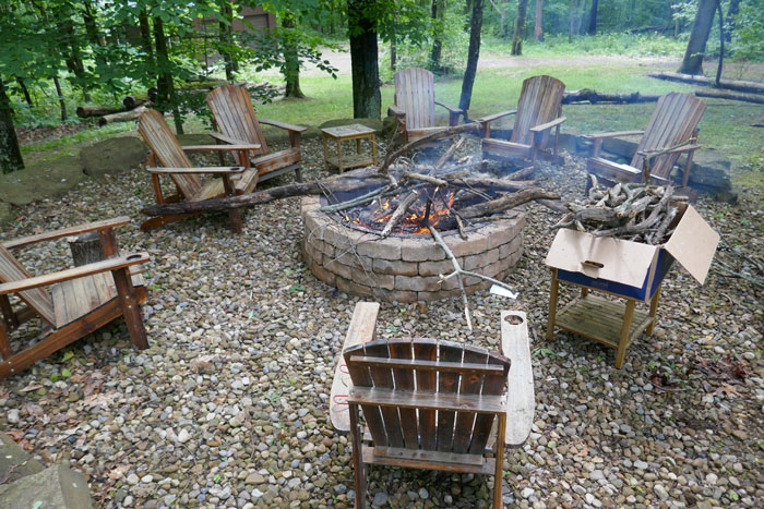 Adirondak chairs circled around a fire pit