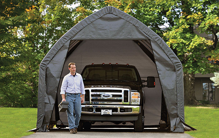 A man standing in front of a portable garageview