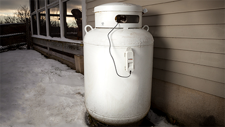 Upright LP tank shown with Generac LTE Fuel Monitor magnetically attached to side of tank.