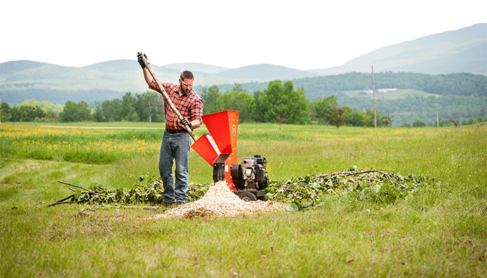 A chipper is used to dispose of tree limbs