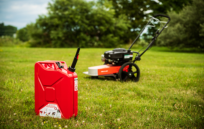 A fuel can accompoanied by a lawn trimmer.