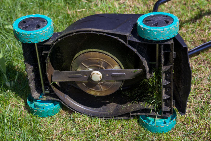 Tilting the mower on its side is more stable than raising the front.