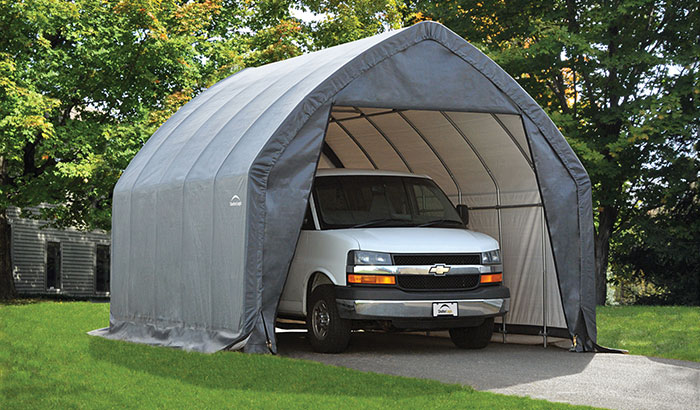 A van parked inside a portable garage.